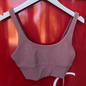 BeachRiot dusty pink ribbed textured sports bra with straight straps.